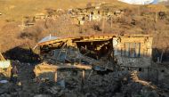 A villager walks by a collapsed house after an earthquake in Sivrice near Elazig, Eastern Turkey, on January 25, 2020. AFP / Ilyas AKENGIN