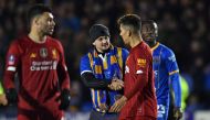 A Shrewsbury fan shakes hands with Liverpool's Brazilian midfielder Roberto Firmino after the final whistle in the English FA Cup fourth round football match between Shrewsbury Town and Liverpool at the Montgomery Waters Meadow Stadium in Shrewsbury, nort