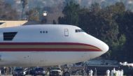 Personnel in protective clothing approach an aircraft, chartered by the U.S. State Department to evacuate government employees and other Americans from the novel coronavirus threat in the Chinese city of Wuhan, after it arrived at March Air Reserve Base i