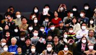 Visitors wearing surgical masks attend the opening ceremony of the Ariake Arena, which will host volleyball and wheelchair basketball competitions in Tokyo 2020 Olympic Games in Tokyo, Japan, yesterday.
