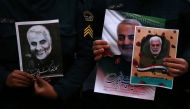 Iranian guards hold a picture of the late Iranian Major-General Qassem Soleimani in Tehran, Iran January 3, 2020. West Asia News Agency / Nazanin Tabatabaee via Reuters