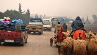 Syrians fleeing with their belongings pass through the town of Batabo in the Aleppo province, on February 5, 2020, on their way northwards toward the Turkish border amid an ongoing regime offensive. AFP / Aaref Watad
 
