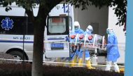 Medical workers in protective suits lift an isolated patient from an ambulance as the country is hit by an outbreak of the new coronavirus, in Chengdu, Sichuan province, China February 2, 2020. Picture taken February 2, 2020. cnsphoto via REUTERS ATTENTIO