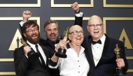Steven Bognar, Julia Reichert and Jeff Reichert pose with the Oscar for Best Documentary Feature for 