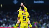Barcelona's Spanish midfielder Sergio Busquets celebrates his goal with Barcelona's Argentine forward Lionel Messi during the Spanish league football match between Real Betis and FC Barcelona at the Benito Villamarin stadium in Seville on February 9, 2020