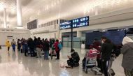 Passengers queue to board a cargo plane, chartered by the U.S. State Department to evacuate Americans and Canadians from China due to the outbreak of novel Coronavirus, at Wuhan Tianhe International Airport in Wuhan, China February 7, 2020. Courtesy of Ed