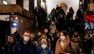 A family wearing a face mask walk in Biblioteka Imeni Lenina metro station in Moscow on February 7, 2020. / AFP / Dimitar DILKOFF 