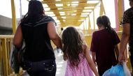 Central American migrants, returned from the U.S. to Nuevo Laredo in Mexico under the Migrant Protection Protocol (MPP) to wait for their court hearing for asylum seekers, are seen walking towards a shelter after arriving to Monterrey, Mexico July 31, 201