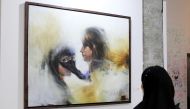 A visitor looks at one of the paintings by Qatari artist Masoud Al Bulushi at W Doha’s Art 29. 