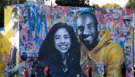  In this file photo taken on January 31, 2020 people take pictures of a mural by French artist Mr. Brainwash of late NBA legend Kobe Bryant and his daughter Gianna in Los Angeles./ AFP / Chris Delmas / 