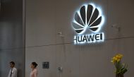 (FILES) In this file photo taken on May 29, 2019, a company logo is displayed at a reception area at the Huawei headquarters in Shenzhen, China's Guangdong province. AFP / Hector Retamal 