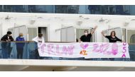 Passengers display a banner reading 'Trump 2020' on the deck of the cruise ship Diamond Princess, where dozens of passengers were tested positive for coronavirus, at Daikoku Pier Cruise Terminal in Yokohama, south of Tokyo, Japan, in this photo taken by K