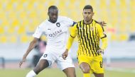 Al Sadd's Abdulkarim Hassan (left) and a player of Qatar SC vie for ball possession during the Ooredoo Cup at the Qatar SC Stadium yesterday.
