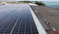 This photograph taken on February 13, 2020 shows solar panels on the roof of the Changi Exhibition centre, where the Singapore Airshow is being held, in Singapore. AFP / Roslan RAHMAN 