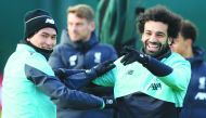 Liverpool's Egyptian midfielder Mohamed Salah (R) jokes with Liverpool's Japanese midfielder Takumi Minamino (L) during a training session at Melwood in Liverpool, north west England on February 17, 2020, on the eve of their UEFA Champions League round of