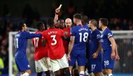 Manchester United's Aaron Wan-Bissaka is shown a yellow card by referee Anthony Taylor as Chelsea's Mateo Kovacic, Cesar Azpilicueta and teammates react REUTERS/Hannah McKay