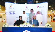 Qatar Chamber Chairman Sheikh Khalifa bin Jassim Al Thani (standing left), witnessing the signing ceremony held on the sidelines of the Made in Qatar’ expo in Kuwait, yesterday. 
