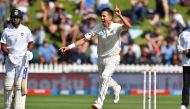 New Zealand's Trent Boult (R) celebrates bowling India's Cheteshwar Pujara and watched by Mayank Agarwal during day three of the first Test cricket match between New Zealand and India at the Basin Reserve in Wellington on February 23, 2020. / AFP / Marty 