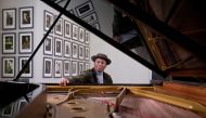 British pianist and composer Alexis Ffrench poses for a photograph after giving an interview at Steinway & Sons in London on February 19, 2020. AFP / Isabel Infantes 