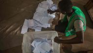 A polling station official counts the marked ballot papers at a polling station in Lome on February 22, 2020 during the first round of Togo presidential vote. AFP / YANICK FOLLY