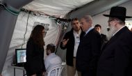 Israeli Prime Minister Benjamin Netanyahu arrives to a tent during his visit to the Chaim Sheba Medical Center at Tel Hashomer in Ramat Gan, Israel, for discussion on the coronavirus, February 19, 2020. Heidi Levine/Poolvia Reuters