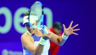 Garbine Muguruza of Spain returns the ball to Russia's Daria Kasatkina during their Round of 64 match of the Qatar Total Open at the Khalifa Tennis Complex in Doha, yesterday. Muguruza won 7-5, 5-7, 6-3.