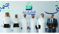 H E Saad bin Sherida Al Kaabi (third left), the Minister of State for Energy Affairs, and President and CEO of Qatar Petroleum, posing for a group picture with some of the long-serving employees who were honoured, yesterday.