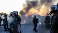 Riot police walk on a road near the town of Madamados as demonstrators protesting against the construction of a new controversial migrant camp on the northeastern Aegean island of Lesbos, on February 25, 2020. AFP / Manolis Lagoutaris 