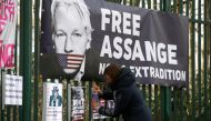 A supporter of WikiLeaks founder Julian Assange posts a sign on the Woolwich Crown Court fence, ahead of a hearing to decide whether Assange should be extradited to the United States, in London, Britain February 25, 2020. Reuters/Henry Nicholls 