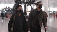 Wall Street Journal reporters Josh Chin (R) and Philip Wen walk through Beijing Capital Airport before their departure on February 24, 2020. AFP / Greg Baker 