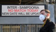 A man wearing mask stands outside the San Siro stadium after Serie A match was cancelled due to  the coronavirus outbreak in Lombardy and Veneto in Milan, Italy, February 23, 2020. Reuters / Daniele Mascolo