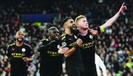 Manchester City's Belgian midfielder Kevin De Bruyne (R) celebrates his goal with teammates during the UEFA Champions League round of 16 first-leg football match between Real Madrid CF and Manchester City at the Santiago Bernabeu stadium in Madrid on Febr