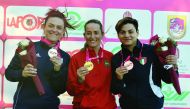 The podium winners in the men's and women's Trap finals of the Qatar Open Shotgun Championship at the Losail Shooting Range posing for photographs yesterday. Pictures: Syed Omar