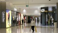 A cleaner worker wearing a mask walks at a shopping mall in central business area, Beijing China, as the country is hit by an outbreak of the new coronavirus, February 2, 2020. Reuters / Jason Lee