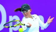 Zheng Saisai of China returns the ball to Aryna Sabalenka of Belarus during the Qatar Total Open on Thursday.