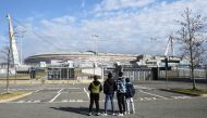 Boys look at the Allianz Stadium, after five Serie A matches were postponed because of the ongoing coronavirus crisis, in Turin, Italy, February 29, 2020. REUTERS/Massimo Pinca