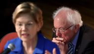 Democratic presidential candidate Sen. Bernie Sanders (I-VT) (R) listens as Sen. Elizabeth Warren (D-MA) speaks at the Ministers Breakfast hosted by National Action Network and Rev. Al Sharpton February 26, 2020 in North Charleston, South Carolina.  Win M
