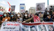 University students girls carry pictures of demonstrators who were killed during ongoing anti-government protests in Baghdad, Iraq March 1, 2020. Reuters/Wissam Al-Okaili