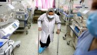 A nurse with a broken leg works in a room where premature babies are under control in incubators at a maternity hospital in Idlib, Syria February 27, 2020. Reuters/Umit Bektas