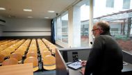University chemistry professor Luca De Gioia uses his tablet to record his lesson in an empty class room to stream it online for his students at the Bicocca University in Milan, Italy, March 2, 2020.  Reuters/Guglielmo Mangiapane
 
 