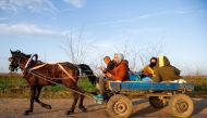 Migrants travel on a horse carriage near the Turkey's Pazarkule border crossing with Greece's Kastanies, near Edirne, Turkey March 3, 2020. Reuters/Huseyin Aldemir