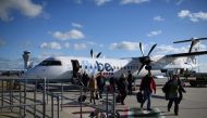 In this file photo taken on November 08, 2017 Passengers dissembark from a FlyBE aircraft after landing at Jersey Airport in St Peter, north of St Helier, on the British island of Jersey. AFP / Oli Scarff
 