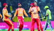 Islamabad United's Dale Steyn (2nd-R) celebrates with teammates after taking the wicket of Lahore Qalandars's Chris Lynn during the Pakistan Super League (PSL) T20 cricket match between Lahore Qalandars and Islamabad United at the Gaddafi Cricket Stadium 