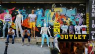 FILE PHOTO: Men sit outside a discount clothing retail store in Istanbul, Turkey, July 13, 2016. Reuters / Murad Sezer