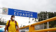 A man walks with a face mask, amid the new coronavirus outbreak, at Rumichaca border bridge in Tulcan, Ecuador March 1, 2020. REUTERS/Daniel Tapia