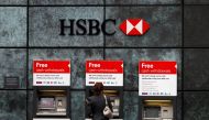 A woman uses a cash point machine at a HSBC bank in the City of London in a file photo. Reuters / Andrew Winning