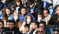 FILE PHOTO: General view of fans wearing face masks in the stands due to the recent outbreak of coronavirus REUTERS/Alberto Lingria
