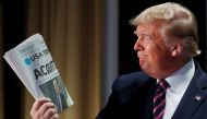 File photo: Donald Trump holds up a copy of USA Today front page news of his acquittal in his impeachment trial as he arrives to address the National Prayer Breakfast in Washington, February 6, 2020. Reuters / Leah Millis