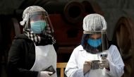 Afghan health workers in protective gears wait to check people during Afghanistan's President Ashraf Ghani inauguration as president, at the Presidential Palace in Kabul, Afghanistan March 9, 2020. Reuters/Mohammad Ismail