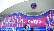 People pose for photograph in front of the Parc des Princes stadium in Paris, on March 9, 2020 two days ahed of the UEFA Champions League Group A football match between Paris Saint-Germain (PSG) and Dortmund. AFP / Franck Fife
